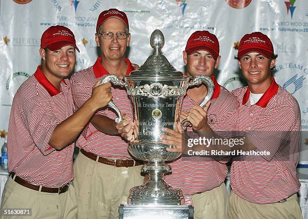 Ryan Moore, Captain Trey Holland, Lee Williams and Spencer Levin of the USA pose with the trophy after the final round was cancelled due to bad...