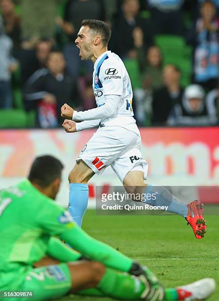 Anthony Caceres of City celebrates scoring a goal as Jamie Young of the Roar looks dejected during the round 24 A-League match between Melbourne City...