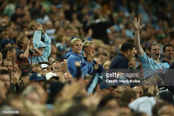 Waratahs supporters in the crowd cheer during the Super Rugby match between the New South Wales Waratahs and the Highlanders at Allianz Stadium on...