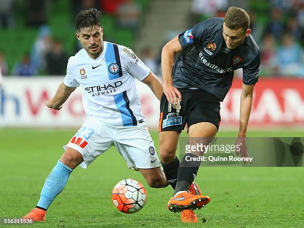 Bruno Fornaroli of City and Daniel Bowles of the Roar compete for the ball during the round 24 A-League match between Melbourne City and Brisbane...