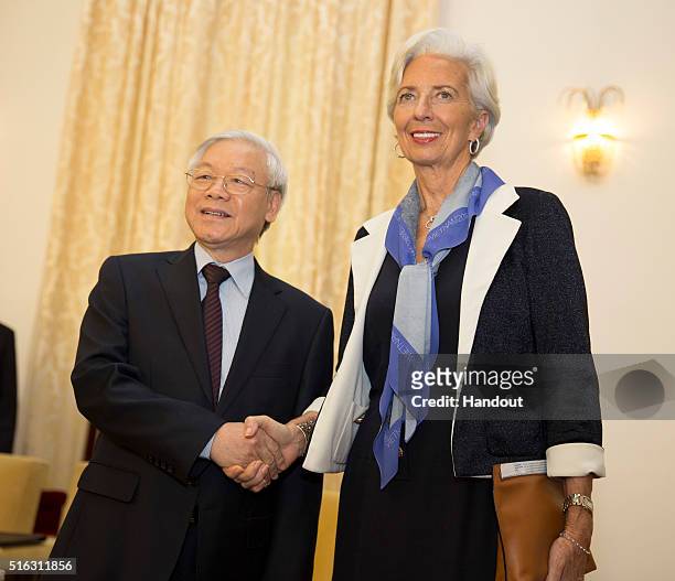 In this handout photo provided by the International Monetary Fund , International Monetary Fund Managing Director Christine Lagarde shakes hands with...