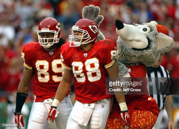 Tight end Tony Gonzalez of the Kansas City Chiefs is congratulated by mascot K.C. Wolf and teammate Jason Dunn after scoring his second touchdown of...