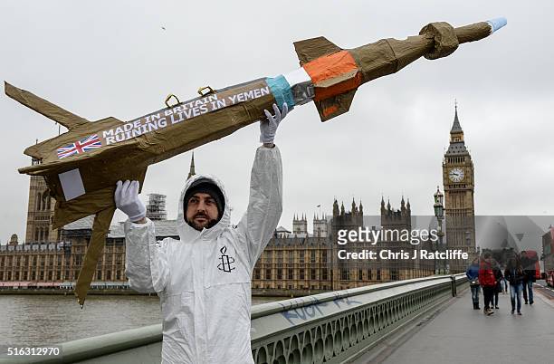 Amnesty International activists march with homemade replica missiles bearing the message 'Made in Britain, destroying lives in Yemen' across...