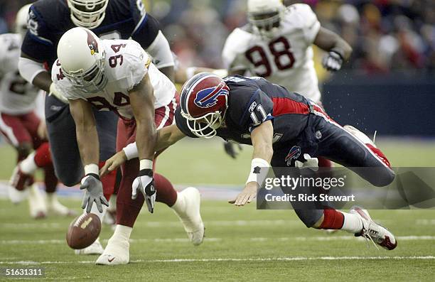 Peppi Zellner of the Arizona Cardinals and Drew Bledsoe of the Buffalo Bills try to get control of a Bledsoe fumble on October 31, 2004 at Ralph...