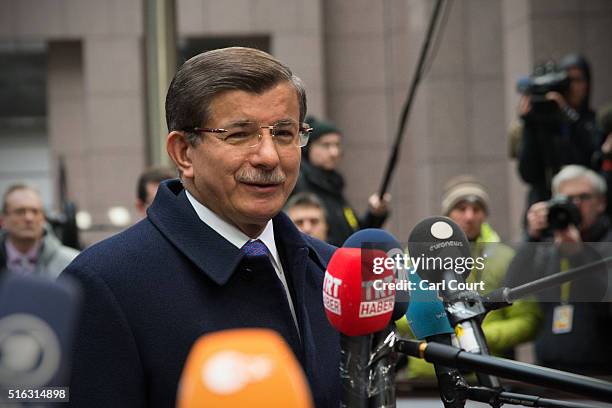 Turkey's Prime Minister, Ahmet Davutoglu, speaks to the media as he arrives at the Council of the European Union on the second day of an EU summit,...