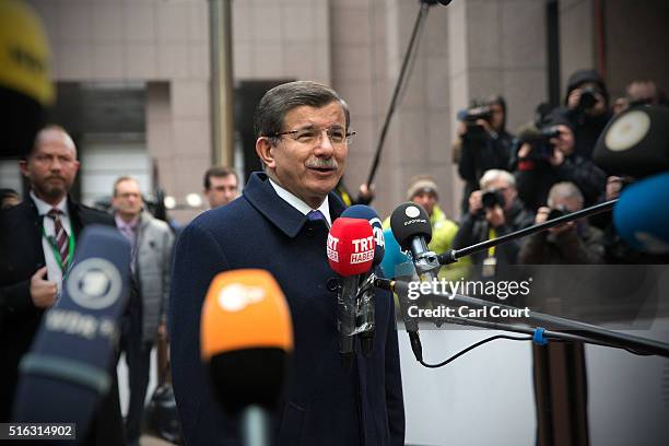 Turkey's Prime Minister, Ahmet Davutoglu, speaks to the media as he arrives at the Council of the European Union on the second day of an EU summit,...