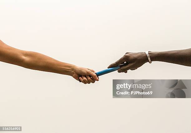 passing the relay baton - track and field team stock pictures, royalty-free photos & images