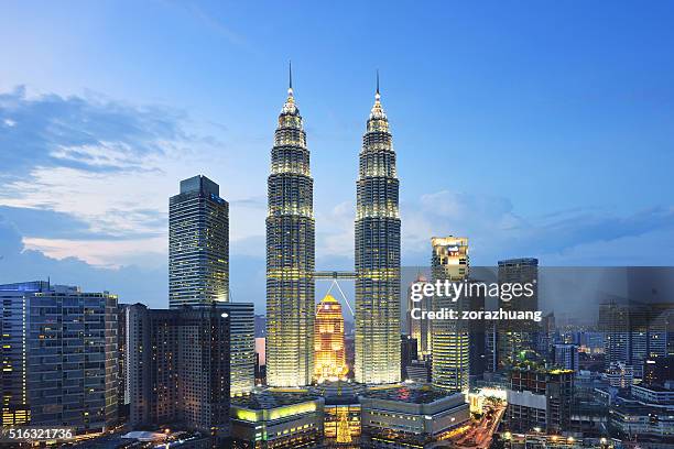 petronas towers at sunset, kuala lumpur, malaysia - kuala lumpur night stock pictures, royalty-free photos & images