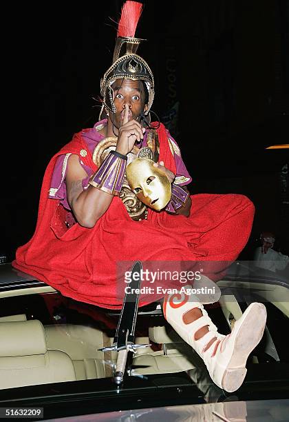 Rapper/producer Sean "P. Diddy" Combs sits on top of his Rolls Royce as he attends singer Mariah Carey's Halloween party at Cain October 31, 2004 in...