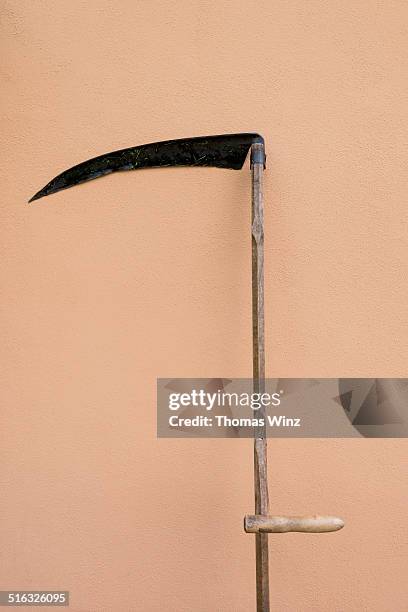 scythe leaning against a wall - sense stock-fotos und bilder