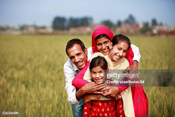 cheerful family portrait - rural indian family stock pictures, royalty-free photos & images