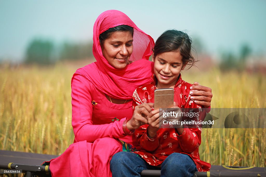 Mother And Daughter Using Smartphone