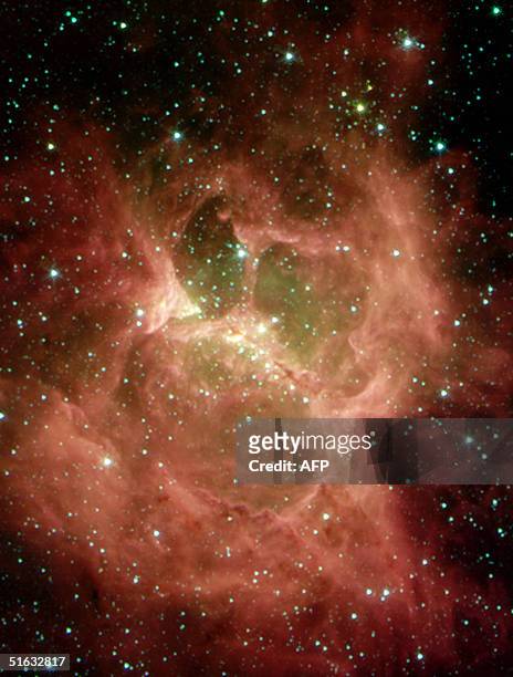 This NASA Spitzer Space Telescope image obtained 01 November, 2004 shows a "monster" lurking behind a blanket of cosmic dust unveiled in this nebula...