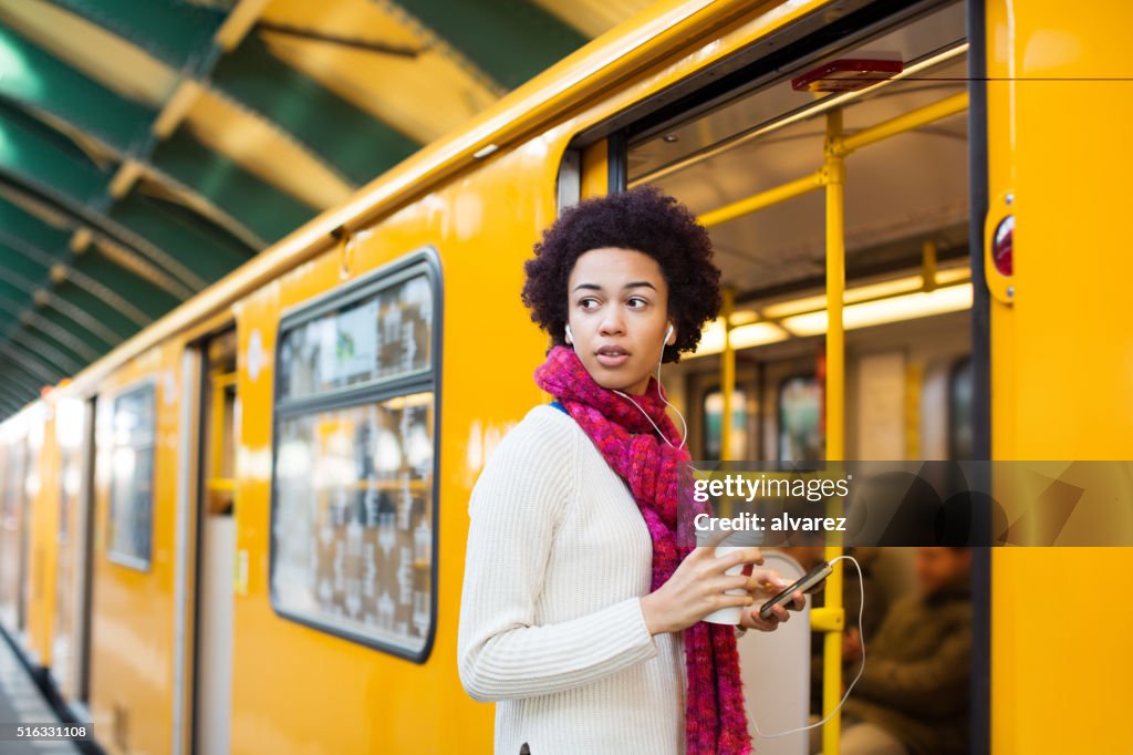 Young african woman boarding a train