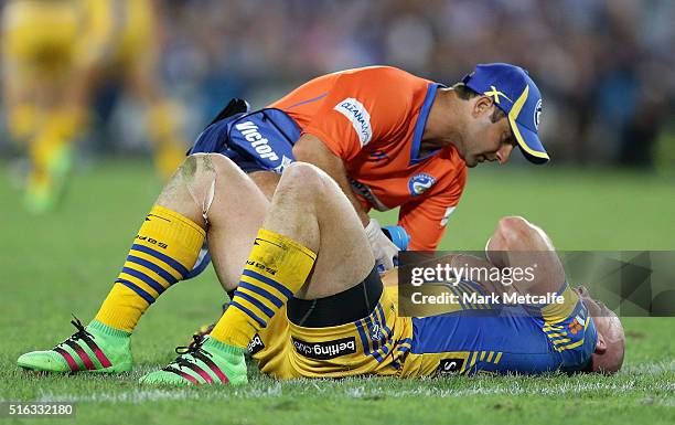 Beau Scott of the Eels lays down holding his shoulder after a tackle during the round three NRL match between the Canterbury Bulldogs and the...