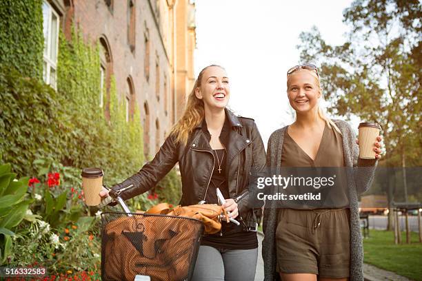 young women on city street with bicycle. - coffee bike stock pictures, royalty-free photos & images