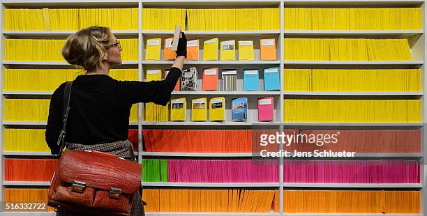 Visitor reaches for a book during the Leipzig Book Fair 2016 on March 18, 2016 in Leipzig, Germany. From March 17 to March 20 more than 2000...