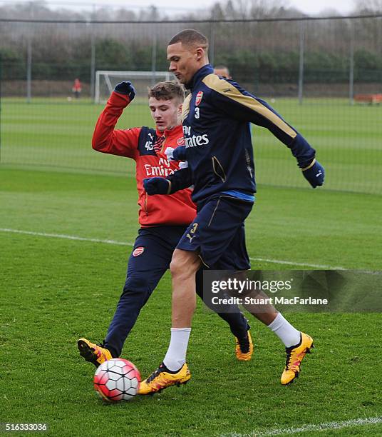 Dan Crowley and Kieran Gibbs of Arsenal during a training session at London Colney on March 18, 2016 in St Albans, England.