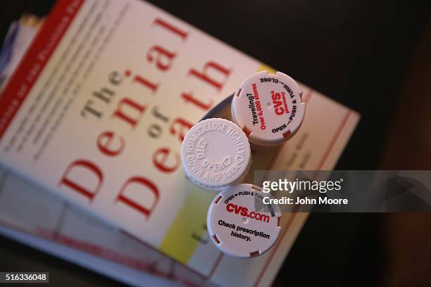 Bottles of prescription medicines stand on reading material in the Manhattan apartment of Youssef Cohen, who has an incurable cancer called...
