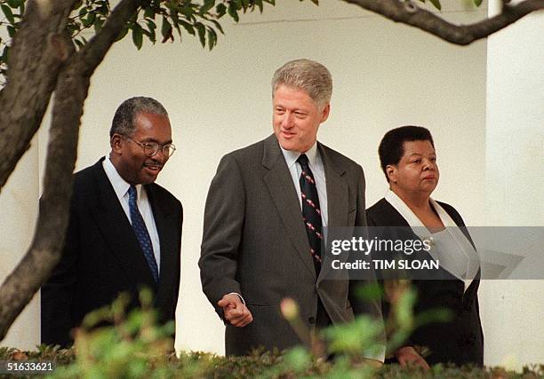 President Bill Clinton walks with Ernest Green and Elizabeth Eckford , two of the original "Little Rock Nine" who integrated Little Rock Central High...