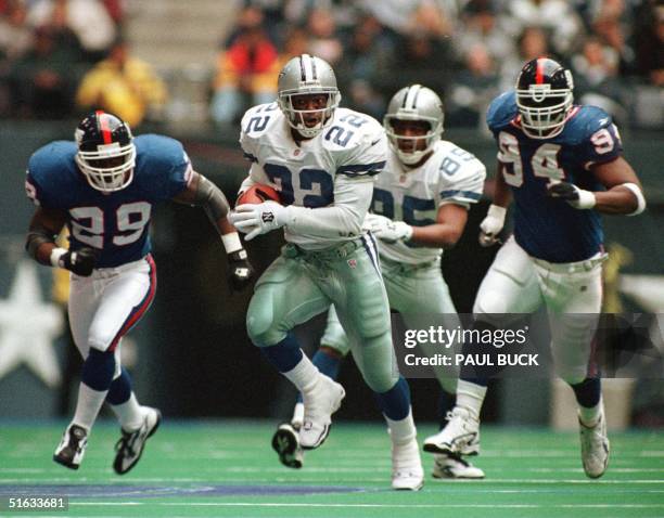 Emmitt Smith of the Dallas Cowboys races for 32 yards during the second quarter of action versus the New York Giants at Texas Stadium in Irving,...