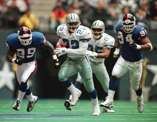 Emmitt Smith of the Dallas Cowboys races for 32 yards during the second quarter of action versus the New York Giants at Texas Stadium in Irving,...