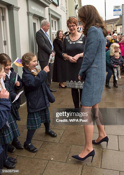 Catherine, Duchess of Cambridge meets children from a local school as she arrives to officially open the new EACH charity shop on March 18, 2016 in...