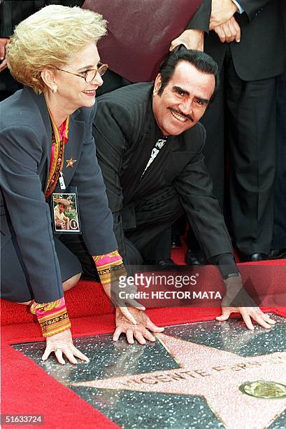 "The King of Mexican Music" Vicente Fernandez poses for photographers along with his wife Cuquita at the Hollywood Walk of Fame11 November where...