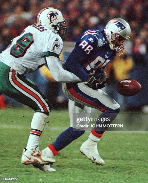 Derrick Rodgers of the Miami Dolphins prevents a reception by Terry Glenn of the New England Patriots in the first half at Foxboro Stadium 23...