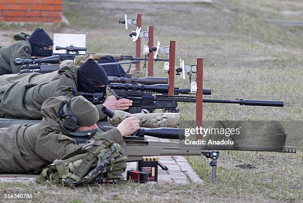 Ukrainian servicemen attend the handover ceremony of small arms for snipers at the Training Center of the National Guard near the village of Novi...