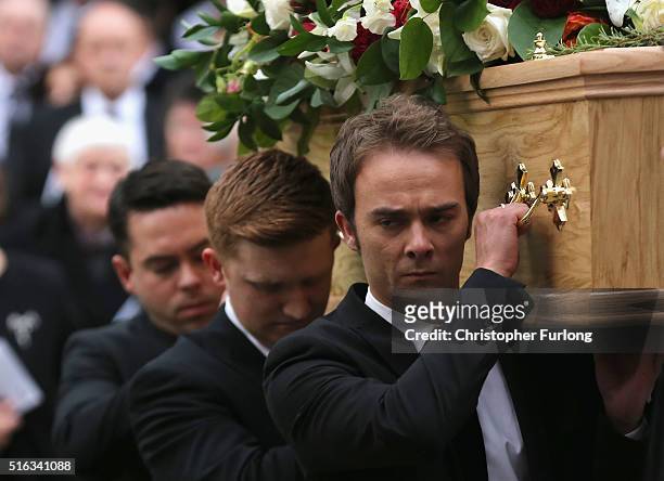 Coronation St cast members Bruno Langley, Sam Aston and Jack P. Shepherd carry the coffin of Coronation Street scriptwriter Tony Warren after his...