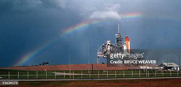Rainbow appears over the US Space Shuttle Endeavour 03 December as it sits on launch pad 39-A at the Kennedy Space Center waiting for its second...