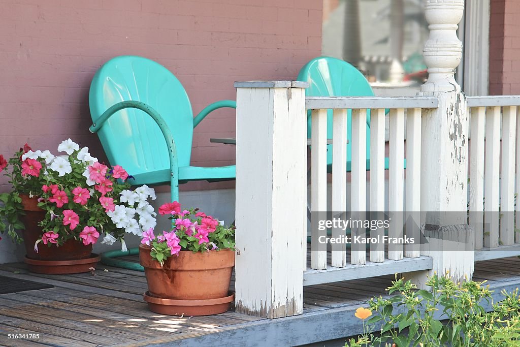 Shady porch with turquoise chairs