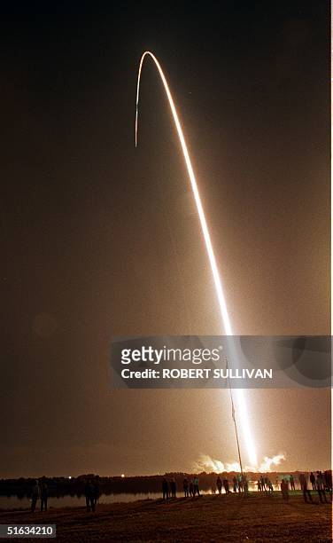 The US space shuttle Endeavour lights up the surrounding area early 04 December as it streaks into space from launch pad 39-A at the Kennedy Space...