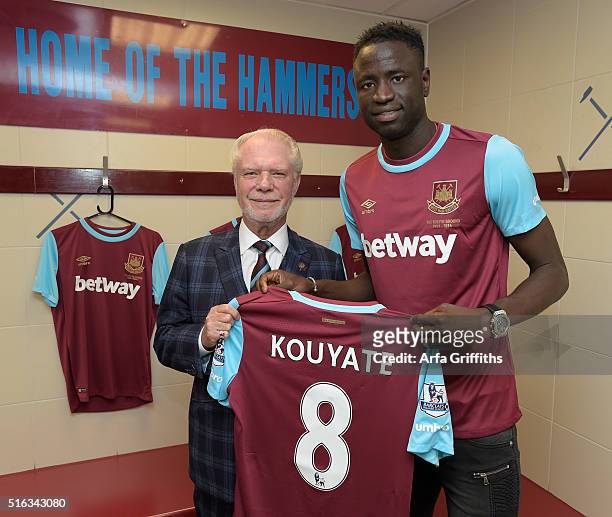 Cheikhou Kouyate of West Ham United with Chairman David Gold after signing a contract extension untill 2021 at Boleyn Ground on March 18, 2016 in...