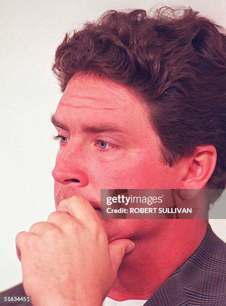 Miami Dolphins quarterback Dan Marino listens as head coach Don Shula announces his retirement 05 January at the team's training facility in Davie,...