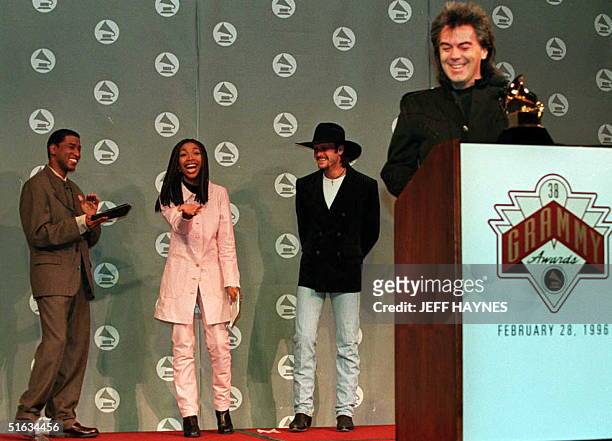 Recording artist Brandy reacts to hearing her name nominated for a Grammy Award by country artist Marty Stuart 04 January as she is flanked by fellow...