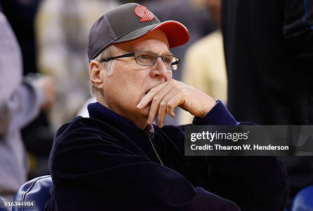 Paul Allen the owner of the Portland Trail Blazers looks on from his seat against the Golden State Warriors during an NBA basketball game at ORACLE...