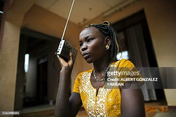 Margret Rumat Rumar Hassan, 19 years old, from Wau, South Sudan, listens to the radio in Juba, South Sudan, on March 18, 2016. Margret is currently...
