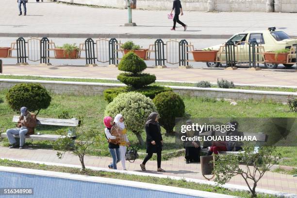 Syrians gather in a park in the coastal city of Latakia, the provincial capital of the heartland of the president's Alawite sect, on March 18, 2016.