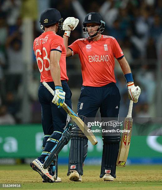 Joe Root of England punches gloves with Jos Buttler after scoring a boundary during the ICC World Twenty20 India 2016 Super 10s Group 1 match between...