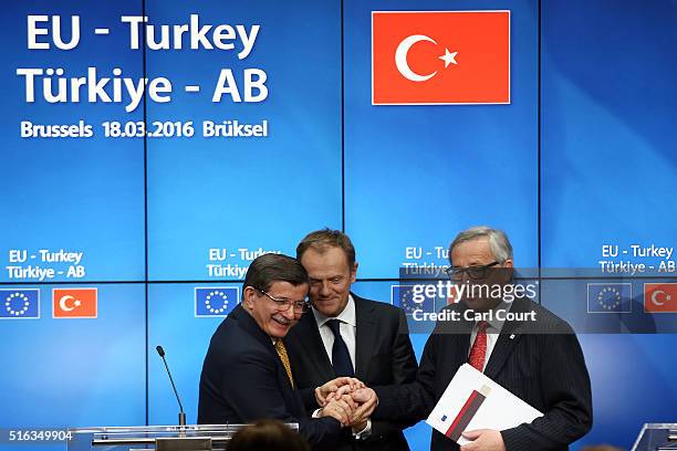 Turkey's Prime Minister, Ahmet Davutoglu shakes hands with President of the European Council, Donald Tusk and President of the European Commission,...