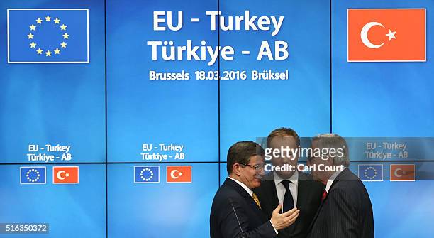 Turkey's Prime Minister, Ahmet Davutoglu shakes hands with President of the European Council, Donald Tusk and President of the European Commission,...