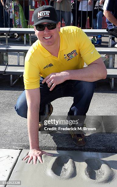 Race car driver Kyle Busch reacts during his Walk of Fame Induction Ceremony at the Auto Club 400 NASCAR Sprint Cup Series Event Weekend at the Auto...