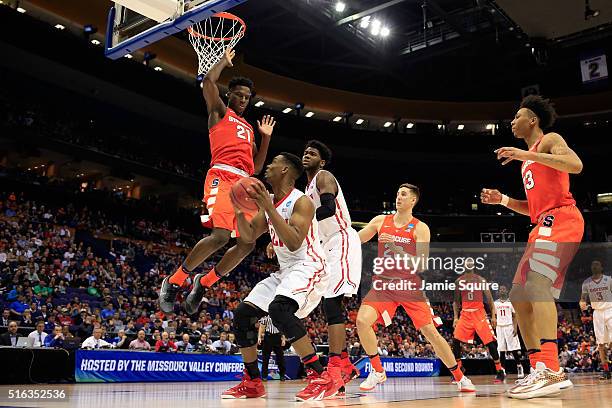 Dyshawn Pierre of the Dayton Flyers drives to the basket against Tyler Roberson of the Syracuse Orange in the second half during the first round of...