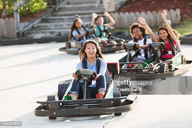 group of teens riding go carts - go karts stock pictures, royalty-free photos & images