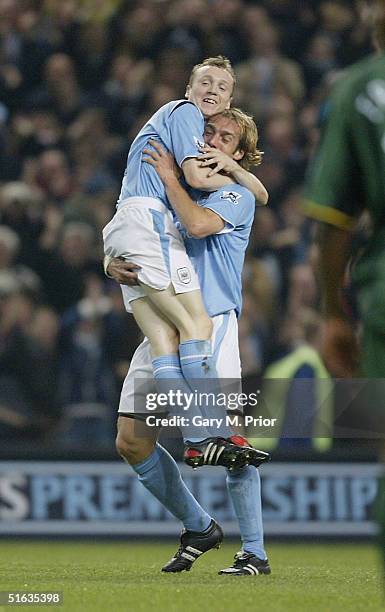 Goalscorer Willo Flood of Manchester City is congratulated by team mate Antoine Sibierski during the FA Barclays Premiership match between Manchester...