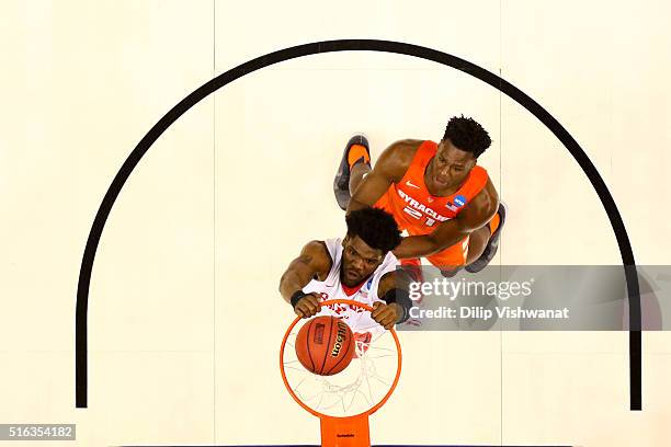 Steve McElvene of the Dayton Flyers dunks against Tyler Roberson of the Syracuse Orange in the first half during the first round of the 2016 NCAA...