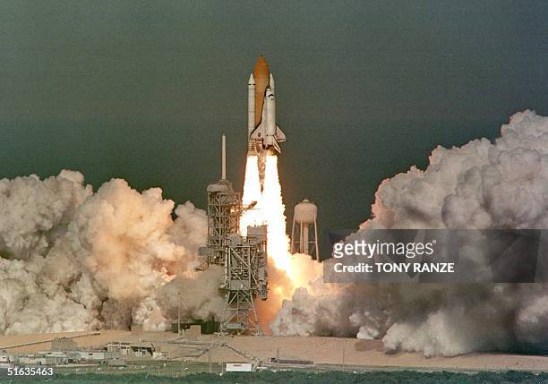 The Space Shuttle Discovery blasts off launch pad 39-B at the Kennedy Space Center, FL 29 October. Discovery flew into orbit with a crew of seven,...