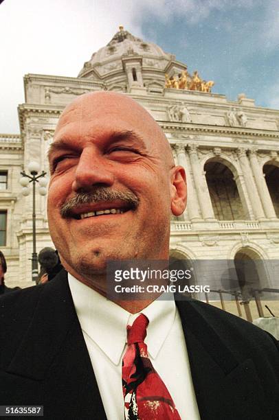 Minnesota Governor-elect Jesse "The Body" Ventura, answers questions outside the State Capitol building after a news conferance with current governor...